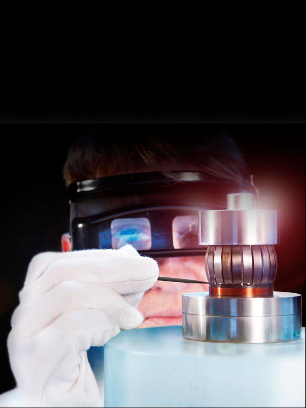 MBL's manufacturing specialist, with magnifying glasses on her head, assembling a filigree Radialstrahler tweeter.